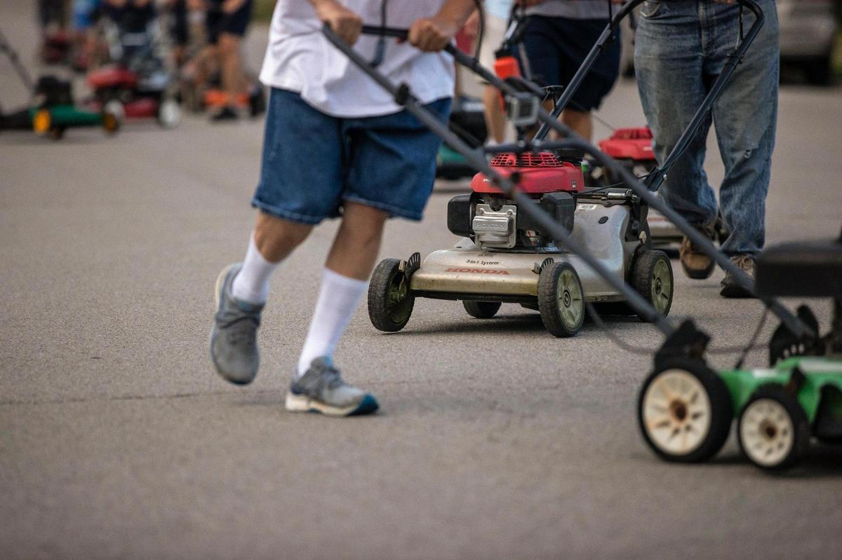 Members of the Wilmore Lawnmower Brigade practice their precision maneuvers in Wilmore, Ky., on Thursday, June 30, 2022.