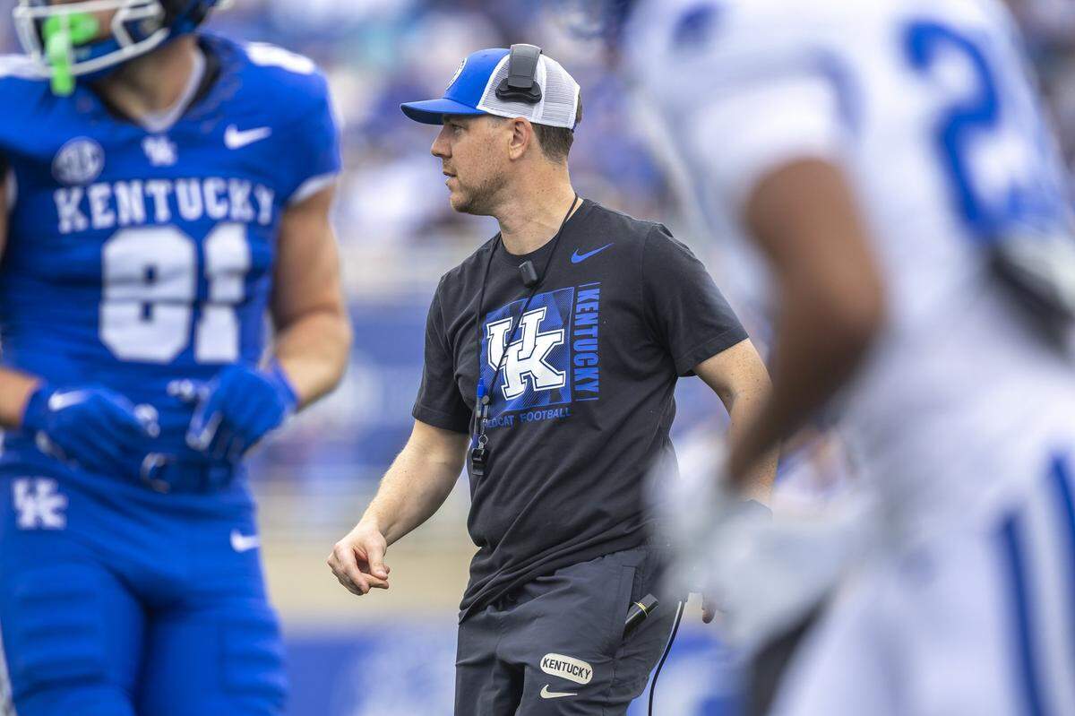 Under the new SEC football scheduling format, Kentucky and new Wildcats head coach Will Stein, center, will have only four annual opponents — Florida, South Carolina, Tennessee and Louisville.