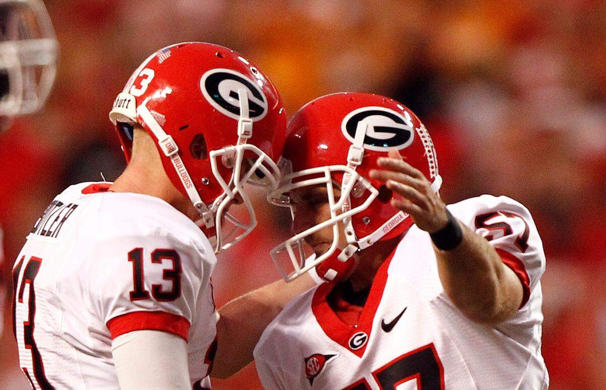 Georgia punter Drew Butler, left, congratulates kicker Blair Walsh after a made field goal during a game in 2011. Butler now leads the college division at Icon Source, a major company in the name, image and likeness landscape.
