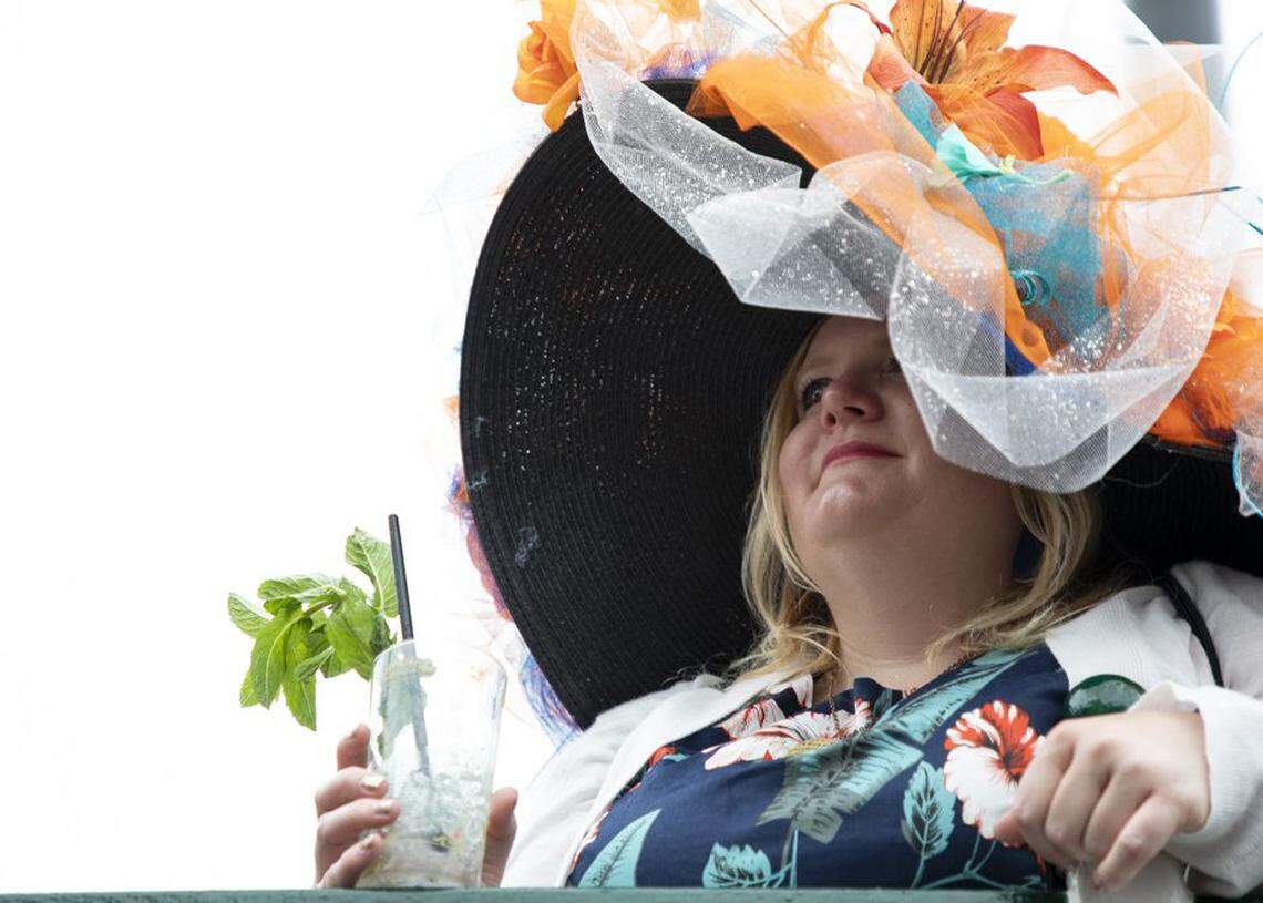 Tawnya Rivers, 37, drank a mint julep and watched as horses come through the tunnel at the 2019 Kentucky Derby in Louisville. She made her own hat to match her dress.