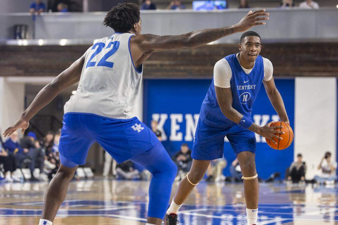 Kentucky forward Brandon Garrison looks to move the ball as center Amari Williams plays defense during the Blue-White Preseason Event at Memorial Coliseum on Friday night.
