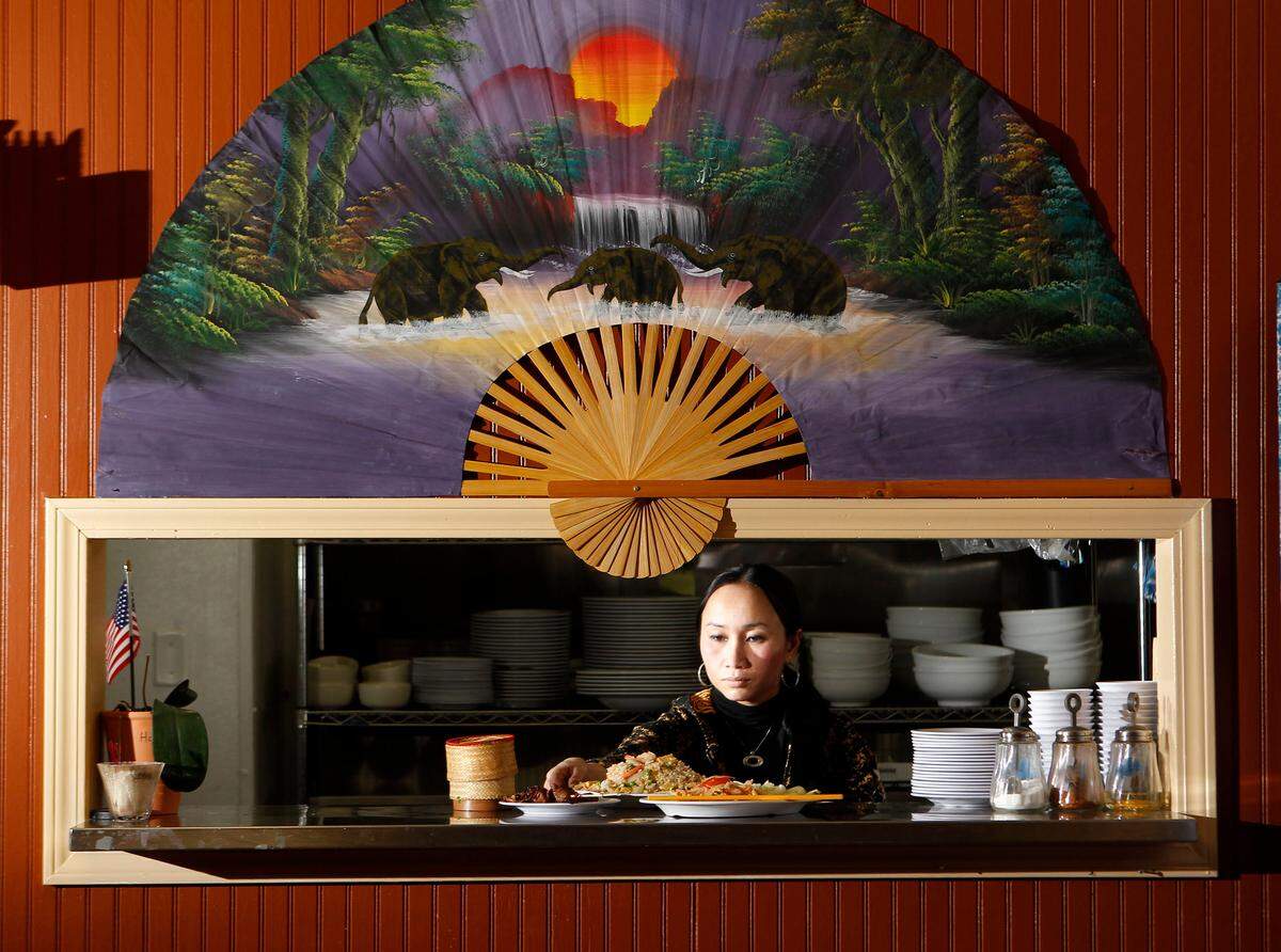 Nipaporn Ruadrew, serves up some food at Jasmine Rice restaurant on Friday January 14, 2011 in Lexington, Ky. The Thai & Vietnamese cuisine restaurant has been sold.