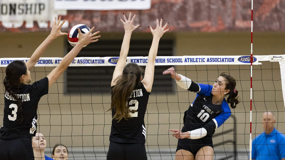 Lexington Catholic’s Payton Avilez (10) tried to deliver her kill attempt through the defense of Assumption’s Julia Lee (3) and Jillian Bohannon (32) during the KHSAA Girls State Volleyball Tournament semifinals at George Rogers Clark High School in Winchester on Nov. 8.