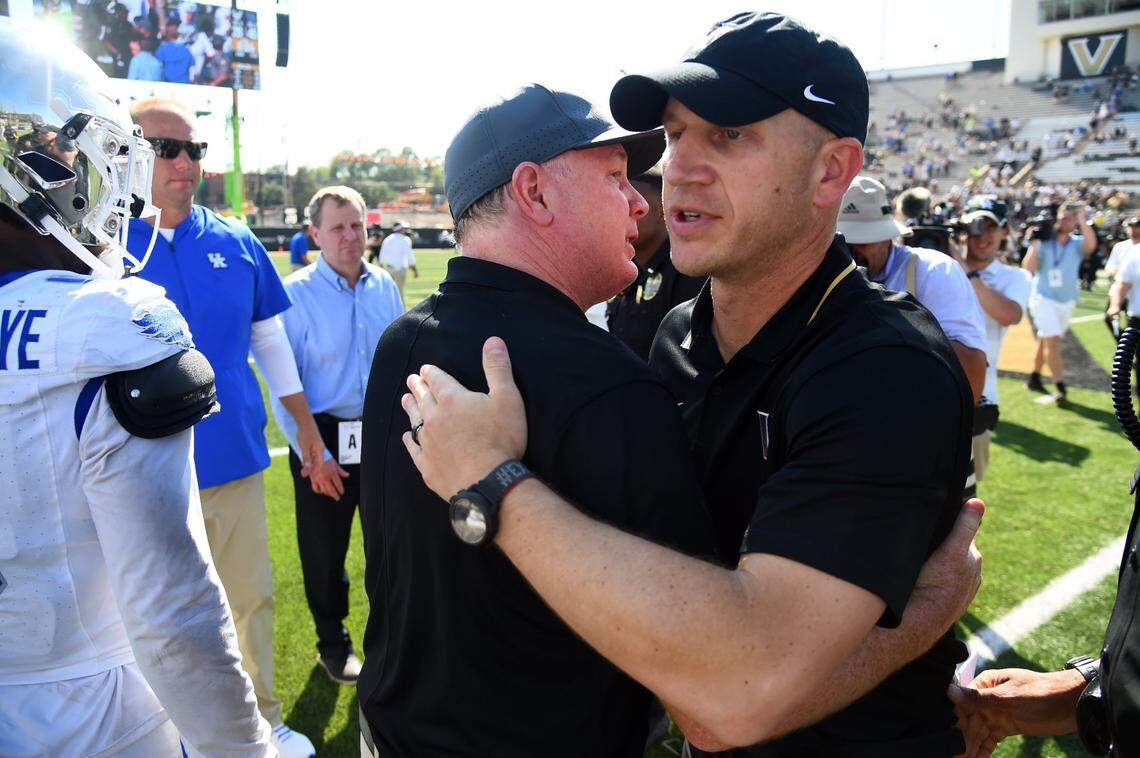 Kentucky coach Mark Stoops, left, and Vanderbilt head man Clark Lea, right, met after UK’s 45-28 win over Vandy last season in Nashville.