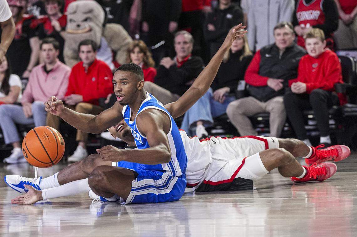Jan 7, 2025; Athens, Georgia, USA; Kentucky Wildcats guard Lamont Butler (1) tries to grab a loose ball behind Georgia Bulldogs guard Tyrin Lawrence (7) during the first half at Stegeman Coliseum. Mandatory Credit: Dale Zanine-Imagn Images