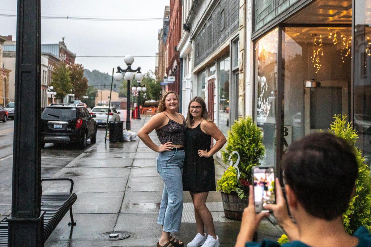 Macy, second from left, meets with her friend, Tatum Williams, to continue a long-standing tradition of taking first-day-of-school photos together outside a bakery in downtown Frankfort on Monday, Aug. 31, 2020 – the first day of school.