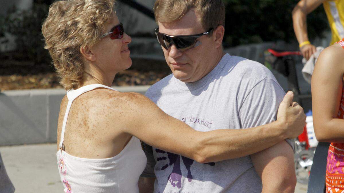 Carol Gensheimer of Georgetown hugged Ryan Hart as the  family of Sarah Hart was introduced before Wednesday's Bluegrass 10,000 awards ceremony. The pregnant 31-year-old was slain last month in Russell County during a run. Ryan Hart is her widower.    