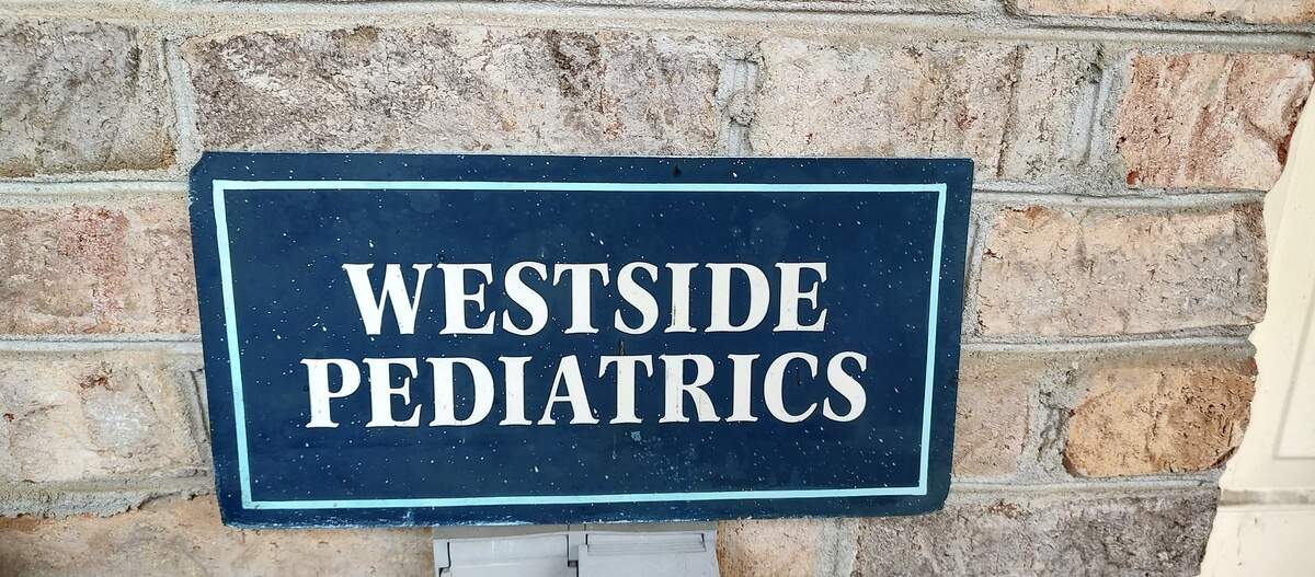 A Westside Pediatrics sign sits on Dr. Rebecca Bosomworth’s front porch in Lexington, KY.