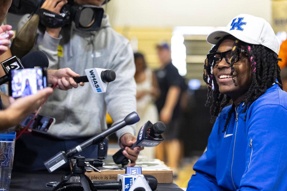 Jasper Johnson, a class of 2025 college basketball recruit and a former Woodford County star basketball player, talks to members of the media after committing to Kentucky on Thursday.