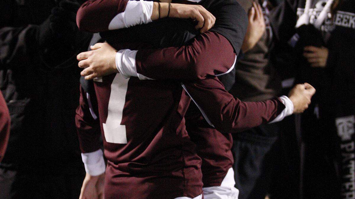 Tates Creek's Mallory Eubanks, left, hugged Jordan Chlebowy after the Lady Commodores toppled unbeaten Notre Dame to win the girls' state soccer title.    