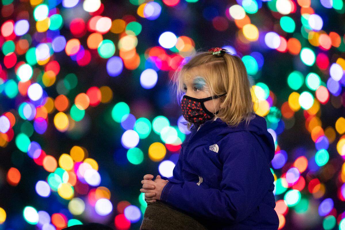 Haley Jennings got a lift from her father, Chad Jennings, during the Luminate Lexington holiday lighting festival at Triangle Park in Lexington Sunday night.