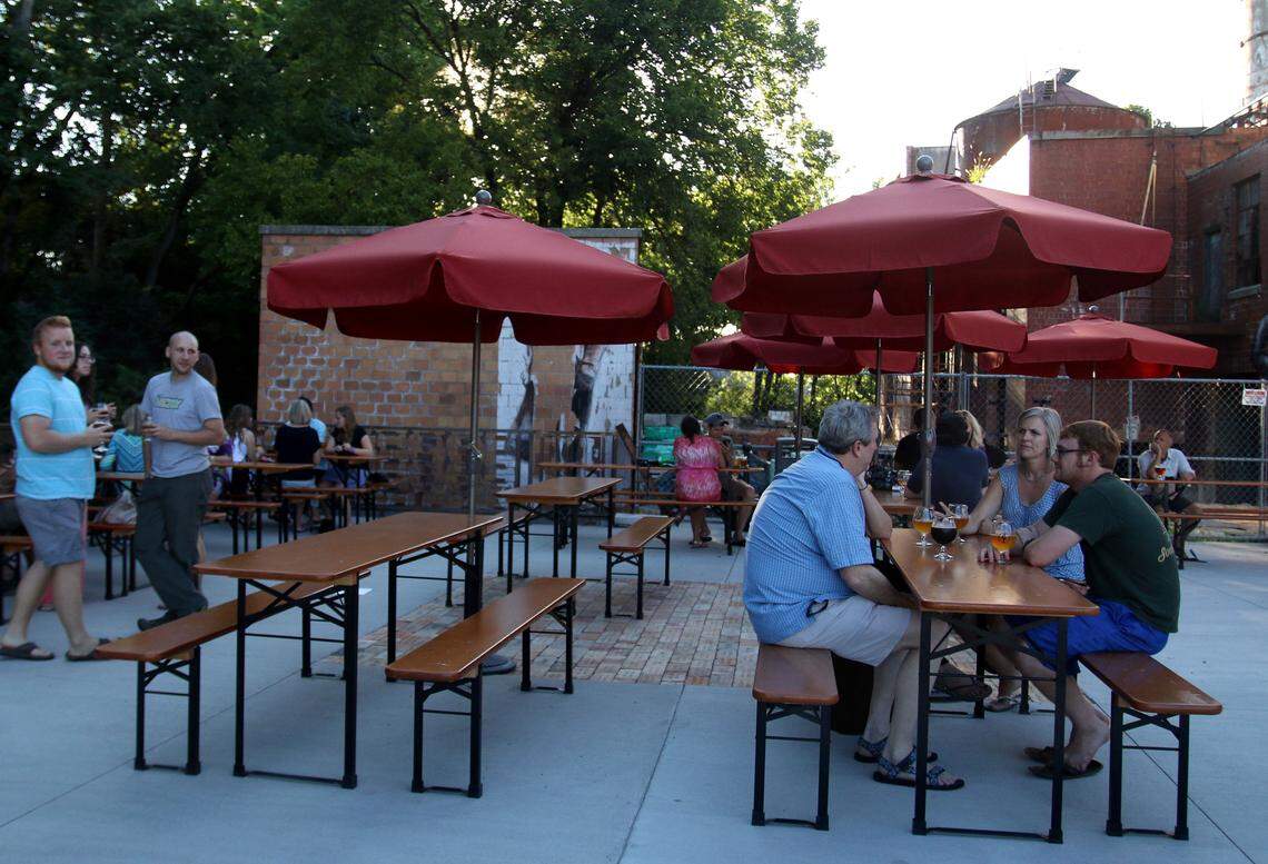 There is a large dining area outside of Middle Fork Kitchen Bar and Ethereal Brewing, near the old Pepper Distillery on Manchester Street. Town Branch flows nearby.