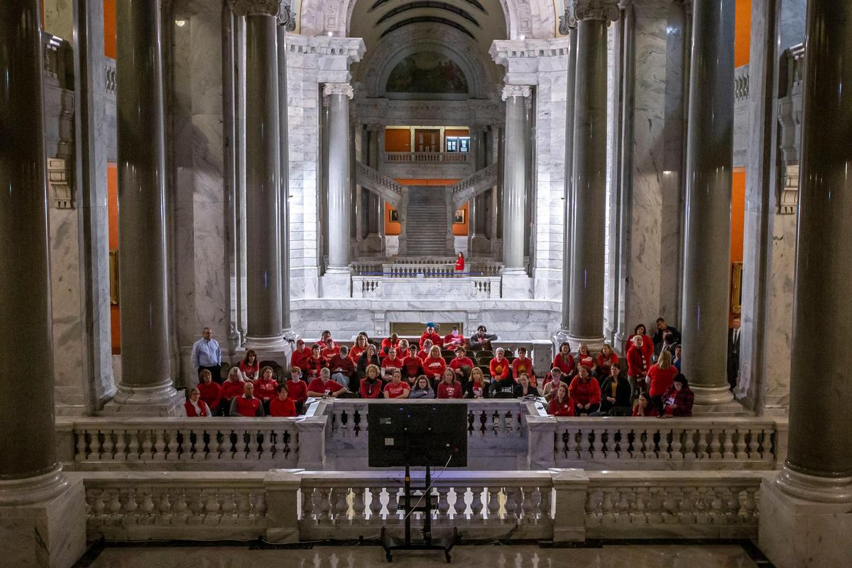 A group of educators watches on a television Kentucky Gov. Andy Beshear deliver his two-year state budget proposal during a joint session of the General Assembly at the Kentucky state Capitol in Frankfort, Ky., on Tuesday, Jan. 28, 2020.
