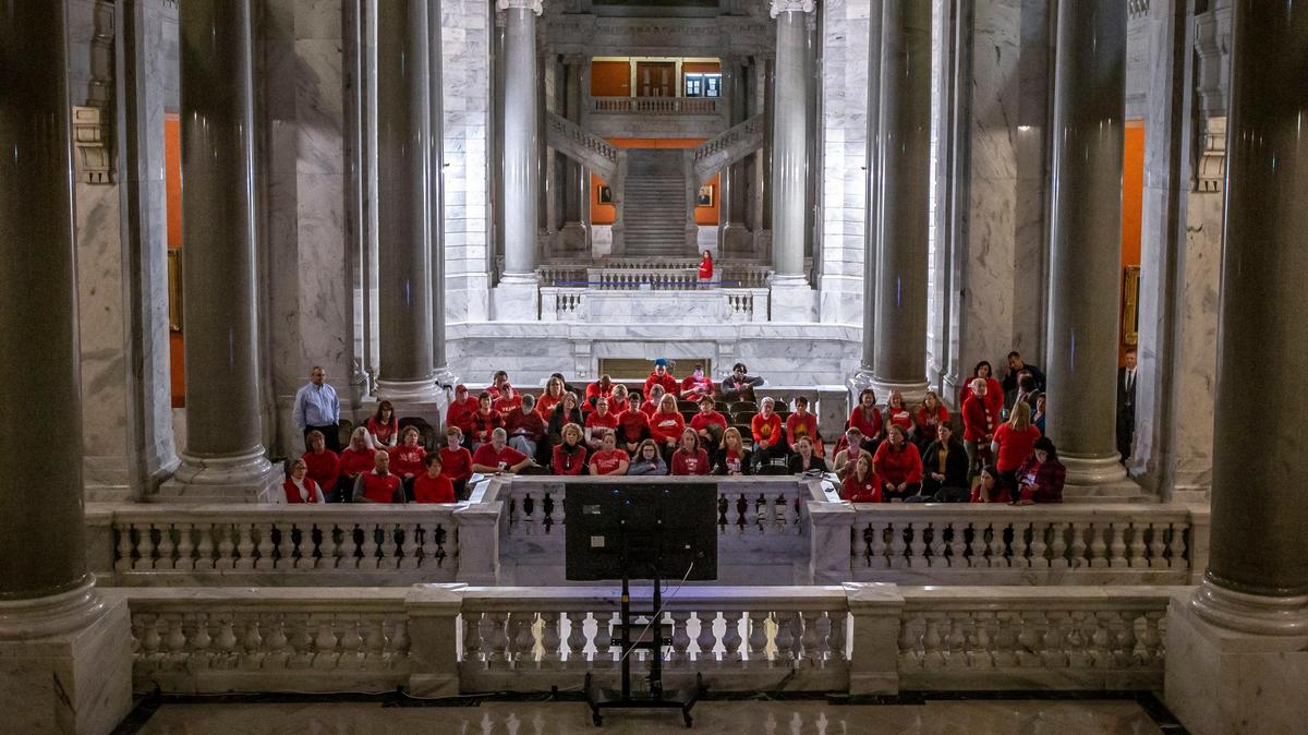 A group of educators watches on a television Kentucky Gov. Andy Beshear deliver his two-year state budget proposal during a joint session of the General Assembly at the Kentucky state Capitol in Frankfort, Ky., on Tuesday, Jan. 28, 2020.