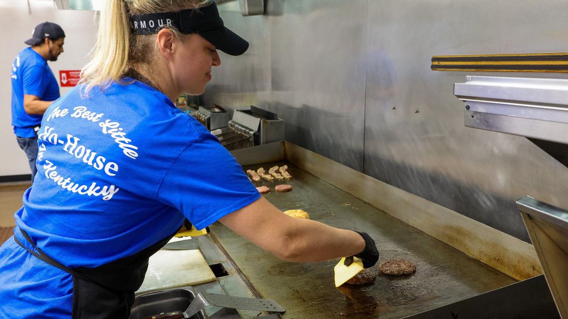 Tolly-Ho Manager Jennifer Milling places cheese on a Super Ho burger Sept. 3, 2024. at the new restaurant location at 350 Foreman Ave. in Lexington, Ky. Milling is the daughter of owner Roy Milling.