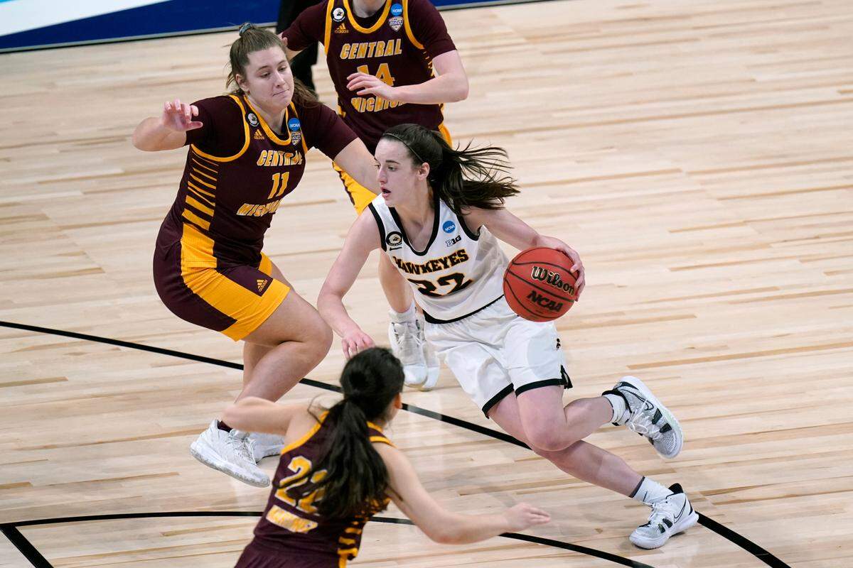 Iowa guard Caitlin Clark (22) drives past Central Michigan guard Micaela Kelly (11) during the second half of a college basketball game in the first round of the women’s NCAA tournament at the Alamodome, Sunday, March 21, 2021, in San Antonio. Iowa won 87-72. (AP Photo/Eric Gay)