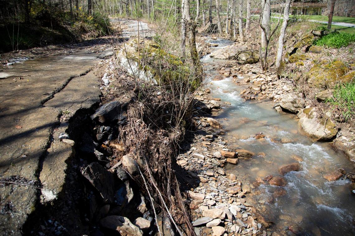 Debris and mud are piled up on the side of Camp Creek Road after heavy rain caused part of the creek to flood and damage roads in Wallins Creek, Ky., Tuesday, March 30, 2021. According to Harlan County Judge-Executive Dan Mosley, the creek will flood with any significant amount of rain and has caused major damage to the road, water line and bridges in the area ten times in the last six years.