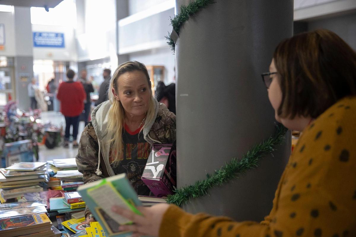 Beverly Kaler picks out toys for her 10 year old daughter, Laken Reilly, with the help of Mayfield Elementary teacher Tiffany Meesa at Graves County Middle School in Mayfield, Ky., on Monday, Dec. 20, 2021, during the distribution of gifts donated for students affected by the deadly tornado that ripped through the county earlier in December.