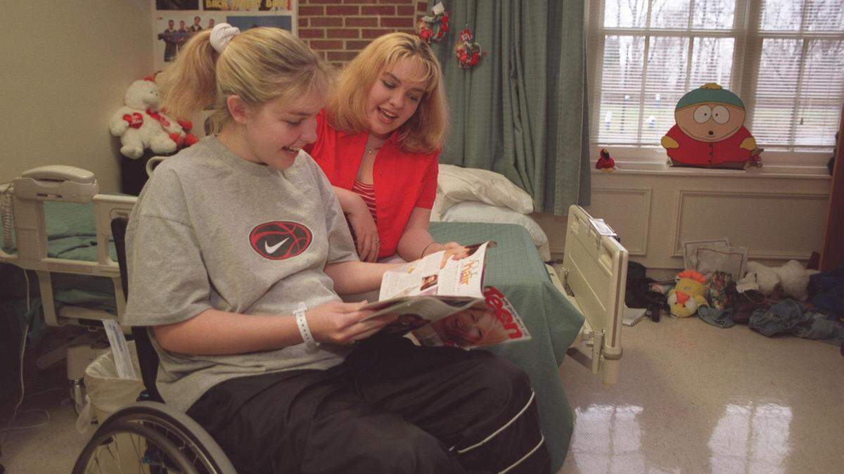 Missy Jenkins, one of several students injured in the shooting at Heath High  School in Paducah, is recovering from her injury at Cardinal Hill Hospital in  Lexington on Monday February 23, 1998. Missy (on the left) and her twin  sister Mandy look over a magazine in Missy s hospital room. The girls are 16. Photo by Charles Bertram | Staff