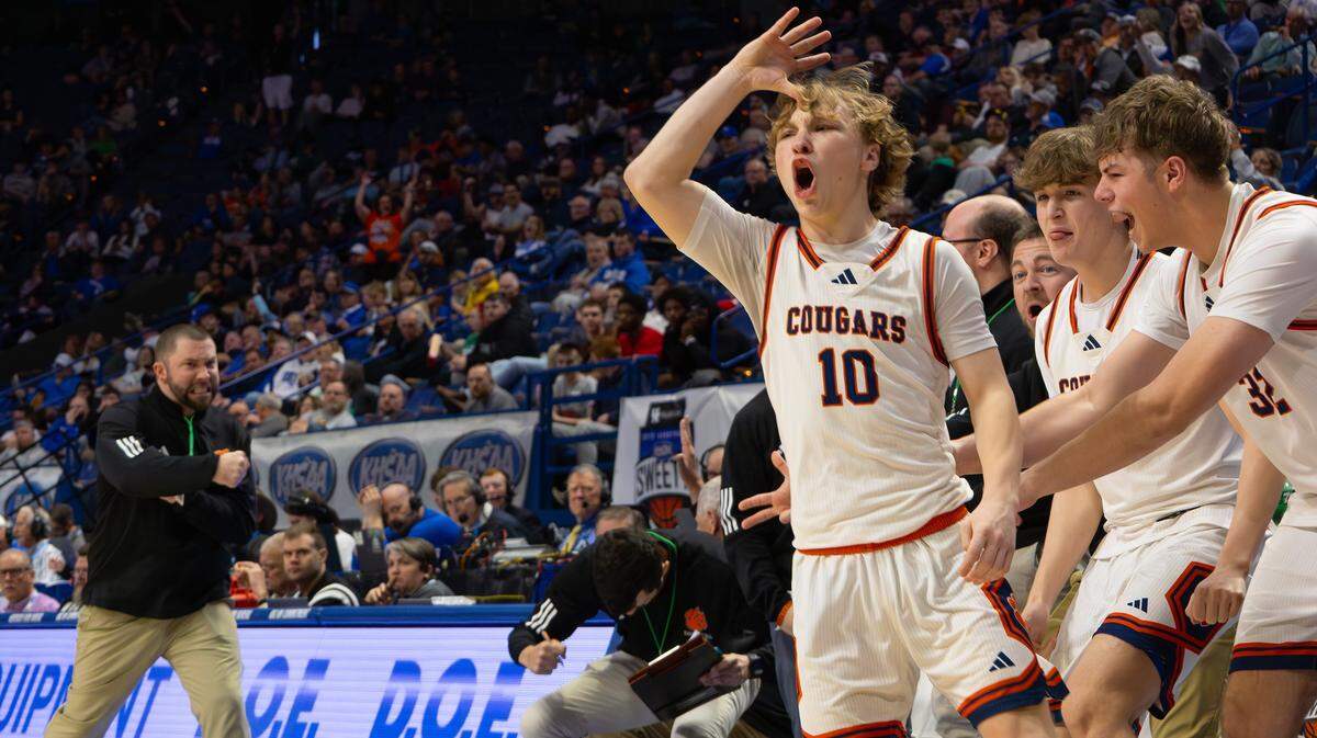 Grayson County's bench celebrates with teammate Chase Baunach after he sinks a three-point shot during the UK HealthCare Boys' Basketball Sweet 16 state tournament quarterfinals matchup between the Great Crossing Warhawks and the Grayson County Cougars at Rupp Arena in Lexington, Ky, on March 20, 2026.