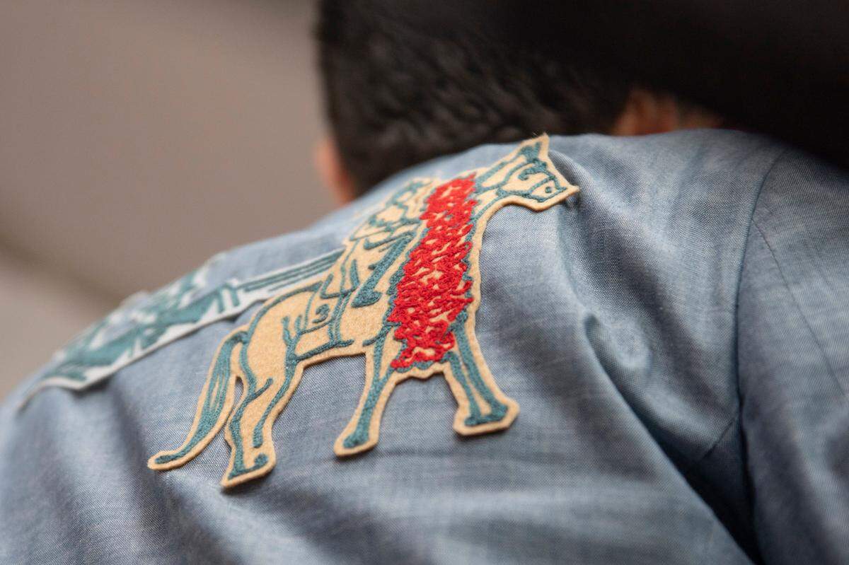 Louisville Mayor Craig Greenberg shows off the patches on his suit jacket on the red carpet at Churchill Downs before the start of 149th Kentucky Derby in Louisville, Kentucky on Saturday, May 6, 2023. He says a friend made the piece for him.