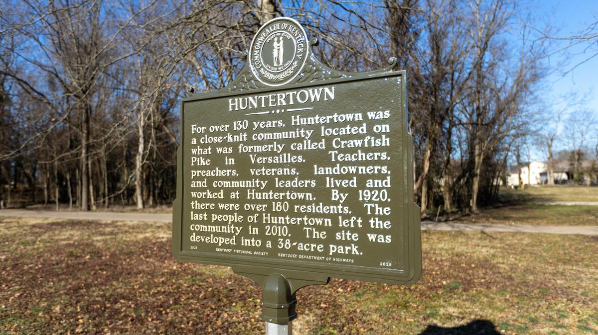 A plaque is raised explaining the history of the historic Versailles Black community Huntertown as Woodford county and UK Architecture students convert the land into an interpretive park to honor the community. Jan. 26, 2022.