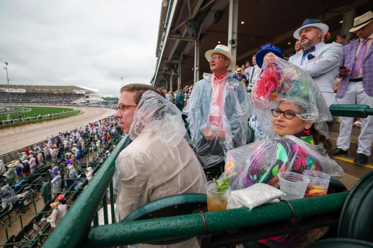 Peggy Sepulveda covered her colorful fascinator&nbsp;while watching an undercard race during Kentucky Derby 151 at Churchill Downs May 3, 2025. 