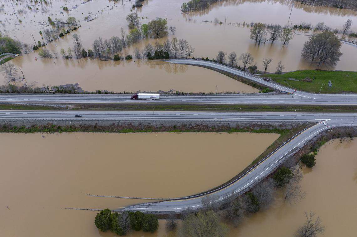 An on- and off-ramp, which have been closed, are covered by water at Exit 10 on the Bluegrass Parkway in Nelson County, Ky., on Monday, April 7, 2025.