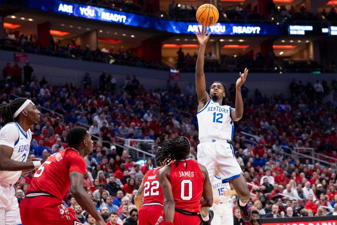 Kentucky’s Antonio Reeves (12) shoots over Louisville’s Mike James (0) during Thursday’s game at the KFC Yum Center. Reeves was named game MVP after scoring 30 points.