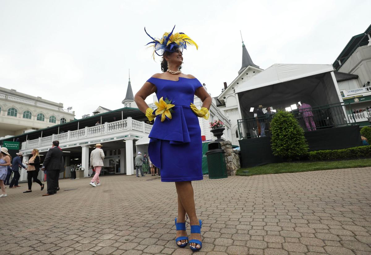 Maria Dasigo, from Hawaii, chose a blue and yellow outfit to show support for Ukraine at Churchill Downs in Louisville, Ky., Saturday, May 7, 2022. She hemmed the dress and used the extra material to add to the flower on the dress.