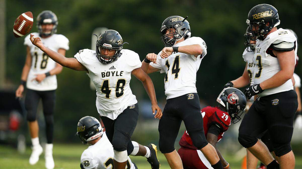 Boyle County’s Ezarious Roller (48) and Hayden Bottoms (14) celebrated after an interception against Ballard.