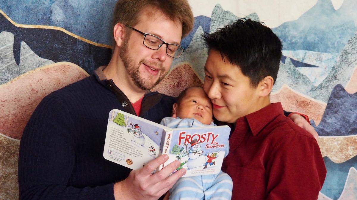 Chris Preece, left with his wife, RuWen, and son, Orion.