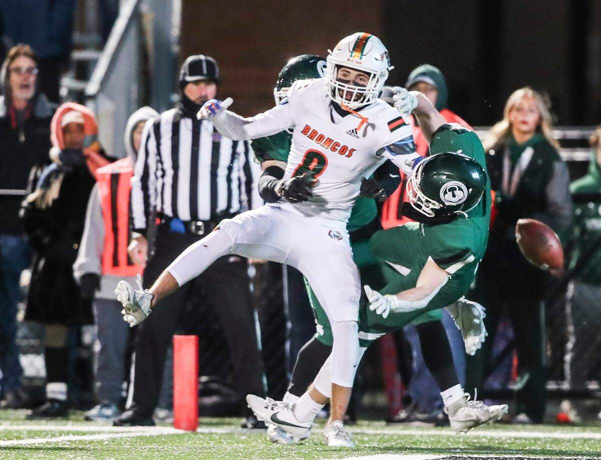 Trinity’s Kaleb Warner and Gabriel Mingus (6) help break up a pass in overtime intended for Graham Dunn of Frederick Douglass.