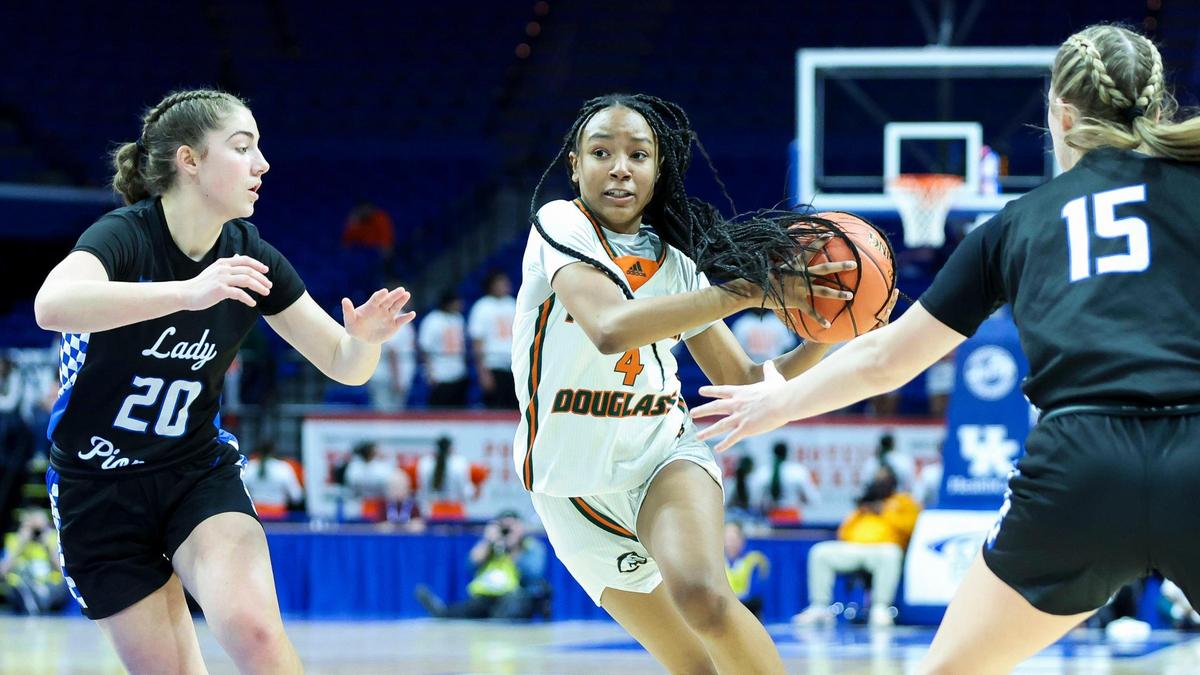 Frederick Douglass’ Tamia Waide (4) drives against Simon Kenton’s Bella Ober (20) and Meg Gadzala (15) during their Girls’ Sweet 16 first-round game in Rupp Arena on Wednesday night. Waide, an eighth-grader, scored a game-high 18 points.