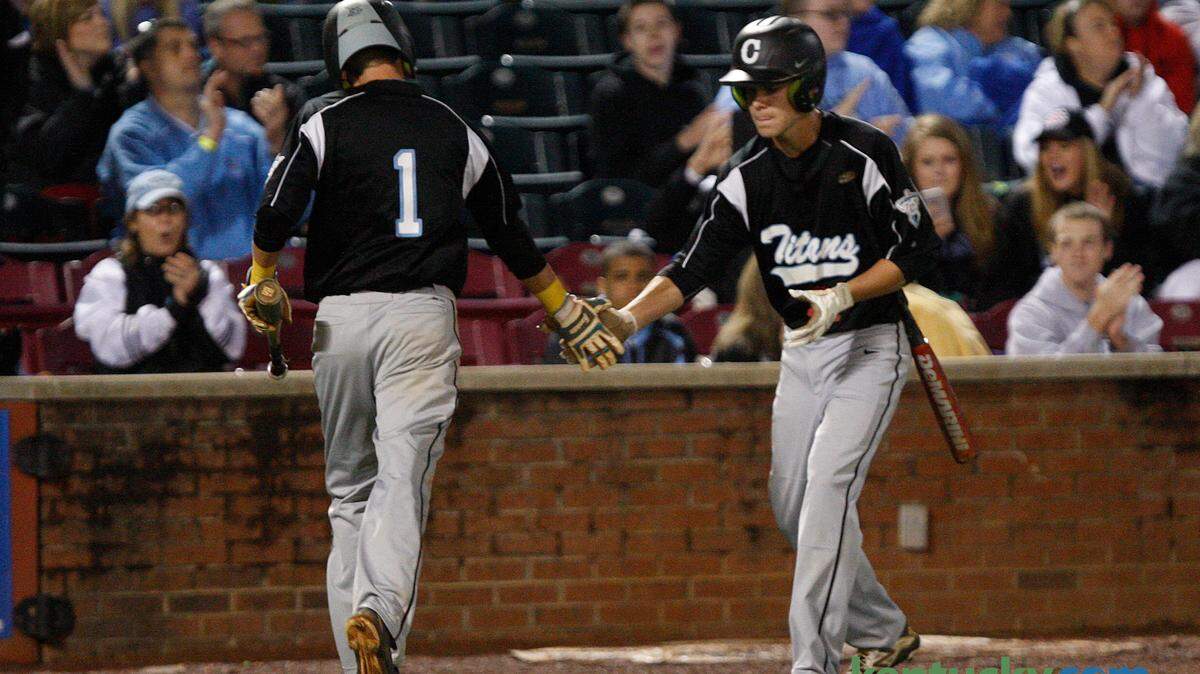 Collins' Bryson Dillon, left, was congratulated by Blanton Creque after scoring in the second inning against Madison Central.