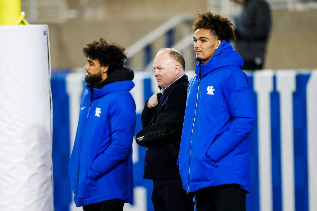 UK wide receiver Dane Key, right, and head coach Mark Stoops watch Frederick Douglass face Bowling Green during the Class 5A state championships at Kroger Field last December. Douglass, Key’s alma mater, won the title.