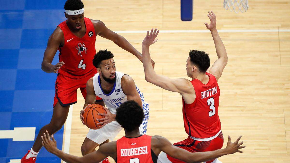 Richmond Spiders forward Nathan Cayo (4) Richmond Spiders forward Souleymane Koureissi (2) and Richmond Spiders forward Tyler Burton (3) guard Kentucky Wildcats guard Davion Mintz (10) during their game at Rupp Arena in Lexington, Ky., Sunday, Nov. 29. 2020.
