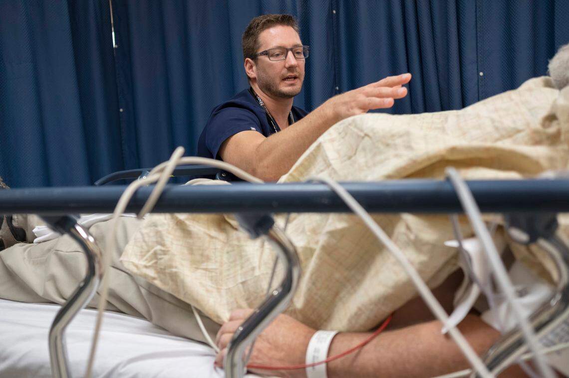 Dr. Philip Overall, medical director of the emergency department at St. Claire Hospital in Morehead, assesses a patient. Overall has spearheaded prescription opioid reduction efforts in the ER.