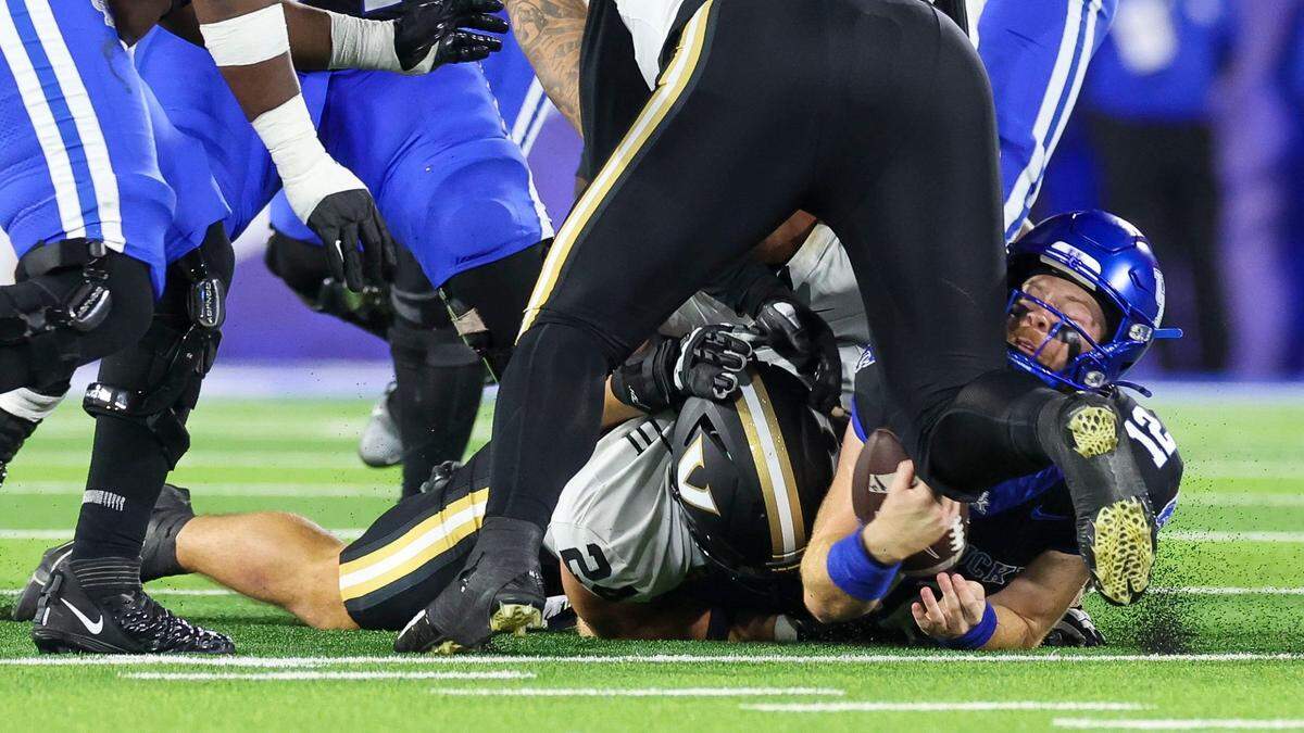 Kentucky quarterback Brock Vandagriff (12) is tackled late during Saturday’s game against Vanderbilt at Kroger Field.