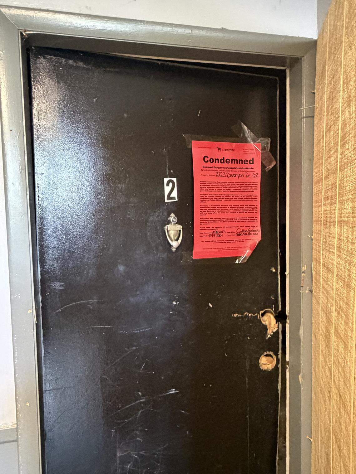 A red “condemned” sign is posted on the door of an apartment building in southwest Lexington. It is one of 57 units that are unlivable.