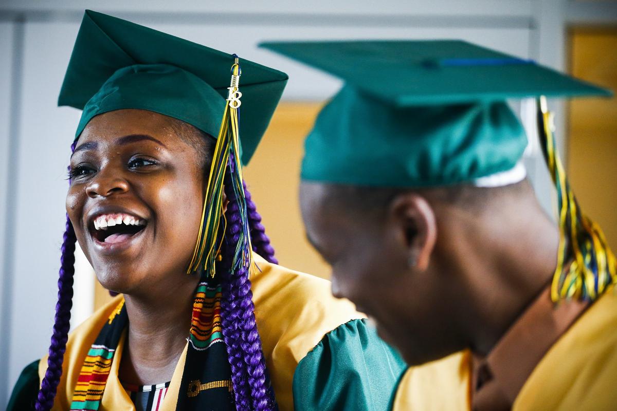 Curtshonna Cannon of Lexington, left, joked with Jaetayvus Clay of Richmond and other former classmates during the All Grads Walk ceremony Thursday at the Lyric Theatre in Lexington. Fifteen students had been turned away from Bryan Station High School's graduation ceremony June 1 because they were late or had not met the dress code.