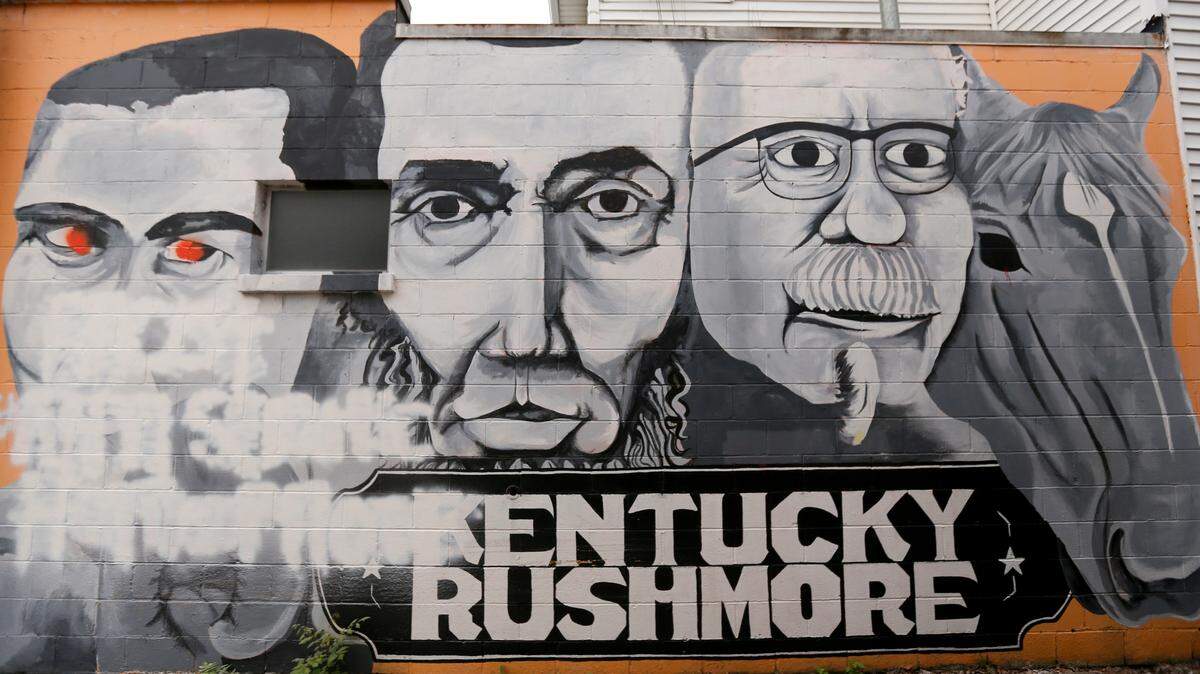 This Thursday, June 13, 2019 photo, shows a popular mural called “Kentucky Rushmore” in the Bardstown section of Louisville, Ky., The Muhammad Ali image of the mural was vandalized. (Scott Utterback/Courier Journal via AP)