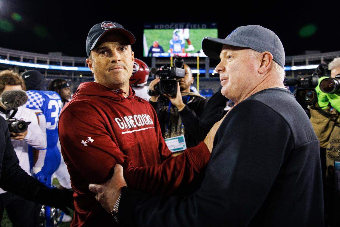 Kentucky coach Mark Stoops, right, greeted South Carolina head man Shane Beamer, left, after the Gamecocks upset the No. 14 Wildcats 24-14 at Kroger Field in 2022.