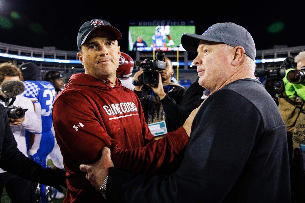 Kentucky coach Mark Stoops, right, shook hands with South Carolina head man Shane Beamer, left, after the Wildcats lost to the Gamecocks 24-14 at Kroger Field in 2022.