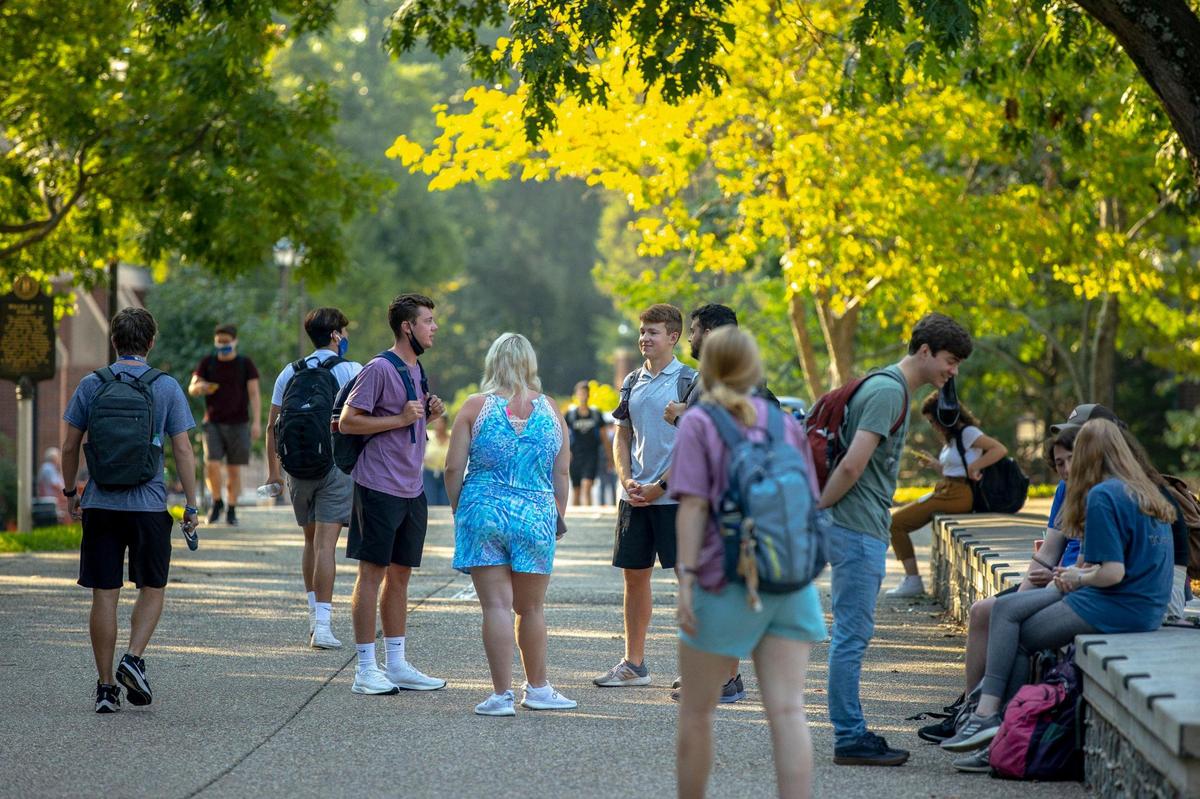 Students walk along the University of Kentucky campus in Lexington, Ky., on the first day of classes for the fall semester Monday, Aug. 23, 2021.