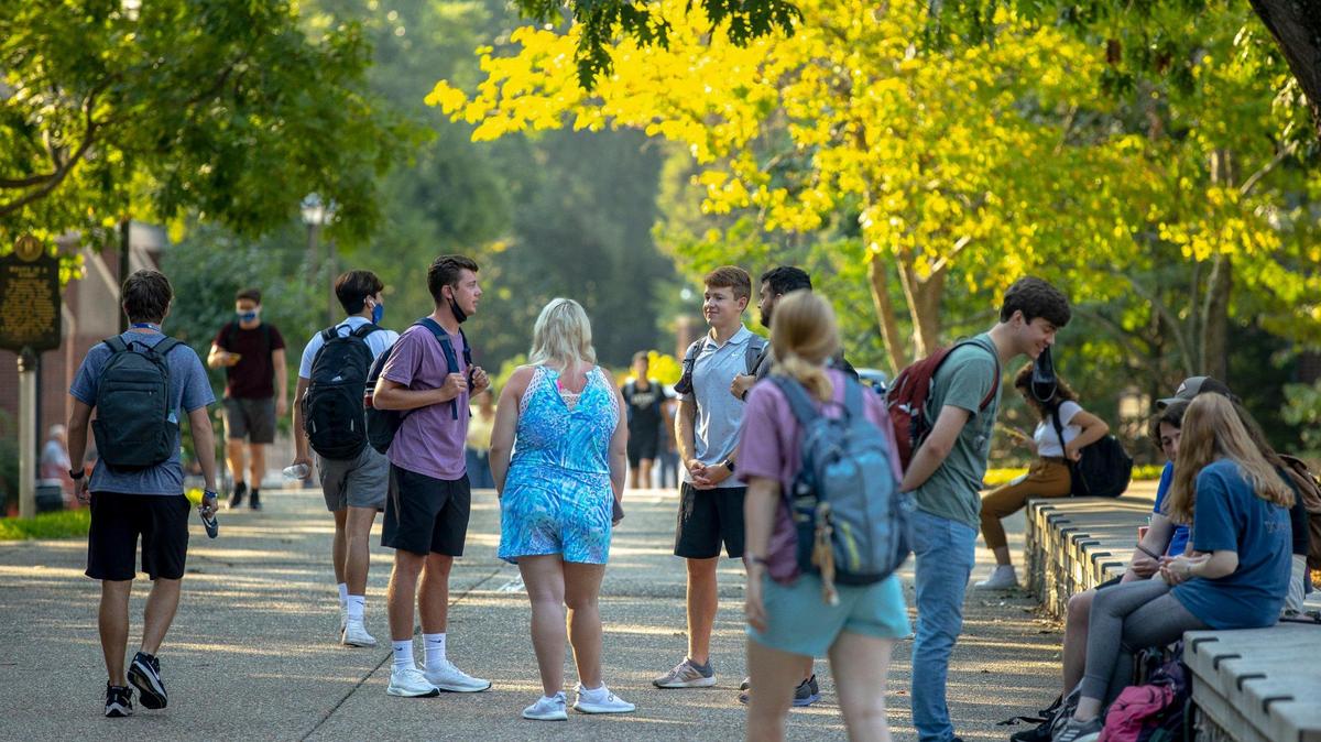 Students walk along the University of Kentucky campus in Lexington, Ky., on the first day of classes for the fall semester Monday, Aug. 23, 2021.