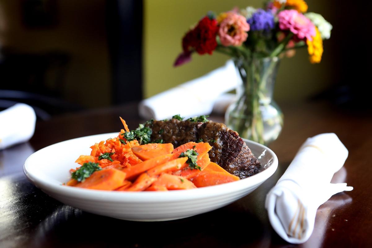 Pot roast entree features chuck roast with potato gratin, honey mustard-glazed carrots and fresh carrot horseradish at Chef Ouita Michel’s Honeywood at The Summit at Fritz Farm.