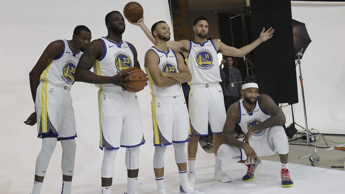 Golden State Warriors, from left, Kevin Durant, Draymond Green, Stephen Curry, Klay Thompson and DeMarcus Cousins posed for photos during media day in Oakland, Calif., before the 2018-19 season.