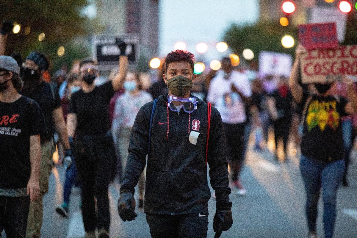 Protesters march through the street of downtown in protest of the decision concerning the officers involved in the killing of Breonna Taylor announced earlier today Wednesday. One officer was charged with three counts of wanton endangerment, but not in the killing of Breonna Taylor.