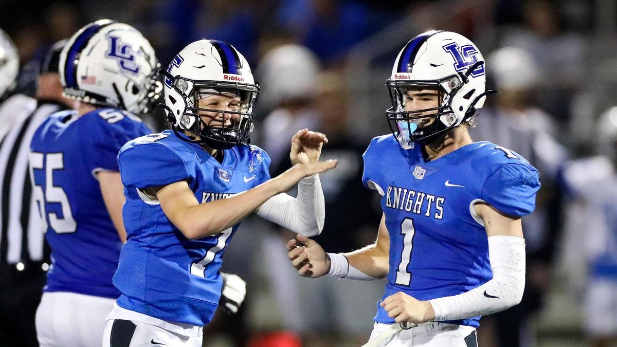 Lexington Catholic’s Jackson Wasik (7) and Max DeGraff (1) celebrate during the Knights’ 42-6 win against Lexington Christian on Sept. 16.